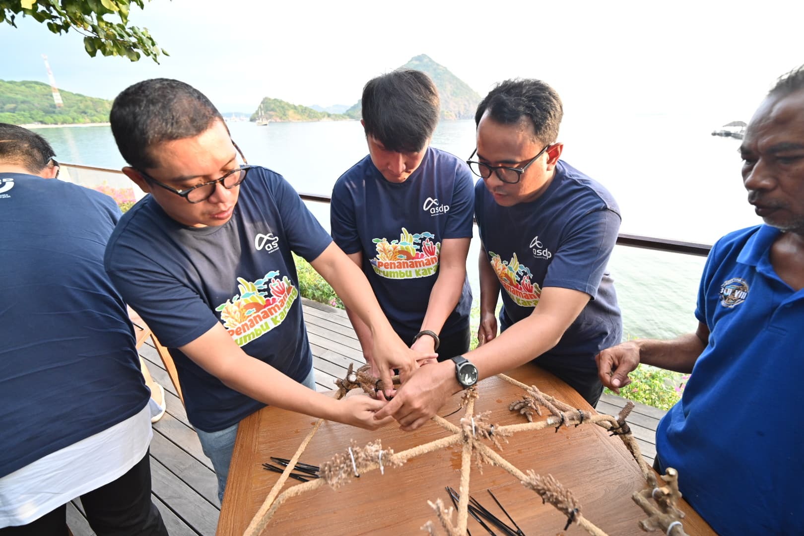 Jajaran direksi dan komisaris ASDP Ferry Indonesia dipandu merangkai bibit terumbu karang pada spiderweb. (foto: dok. ASDP)