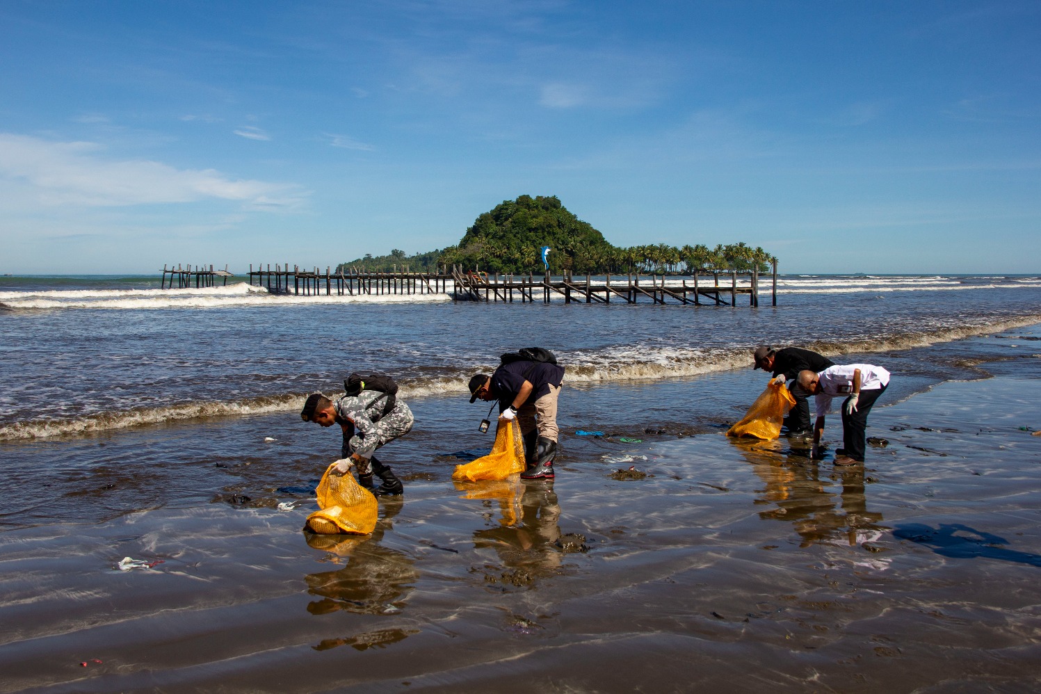 ejumlah masyarakat bersama nelayan melakukan aksi bersih-bersih pantai dari sampah laut di Pantai Air Manis, Padang, Sumatra Barat, Kamis (11/7/2024). (Sumber gambar: Bisnis Indonesia/Muhammad Noli Hendra)
