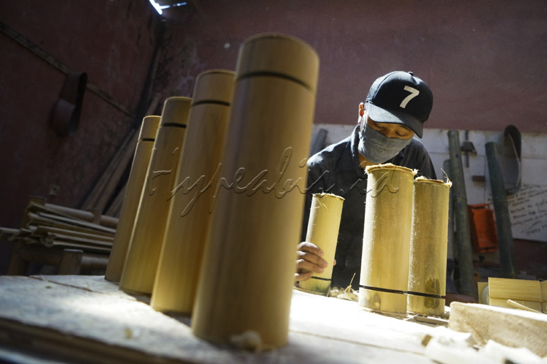 Pekerja menyelesaikan pembuatan tumbler atau wadah minuman dengan kemasan luar berbahan bambu di studio produksi Indonesian Bamboo Community (IBC), Jalan Melong Asih, Kota Cimahi. Semula IBC memproduksi alat musik berbahan bambu, namun saat pandemi produksi dialihkan pada pembuatan tumbler seiring menurunnya permintaan alat musik bambu.&nbsp;<br />
<br />
Mengandalkan bahan baku jenis Bambu Tali atau Bambu Apus, dalam bahasa Latin disebut Gigantochloa apus, produksi tumbler bambu dengan volume 500 ml ini dijual dengan harga antara Rp 100 ribu hingga Rp 250 ribu. Dalam satu bulan, rata-rata produksi mampu menghasilkan sebanyak 250 buah dengan sebaran konsumen di Bandung, Jakarta, Surabaya, Kalimantan hingga Bali.<br />
<br />
Prinsip eco-friendly diterapkan oleh IBC dalam memproduksi wadah minuman yang diberi merek Virageawie ini. Budaya masyarakat untuk menjalani hidup nol sampah, menjadi alasan terciptanya inovasi stainless tumbler yang dibalut dengan kemasan bambu. Selain untuk tampil beda menggunakan wadah minuman dengan ciri khas bambu Indonesia, konsumen dapat mengurangi penggunaan kemasan plastik sekali pakai.<br />
&nbsp;