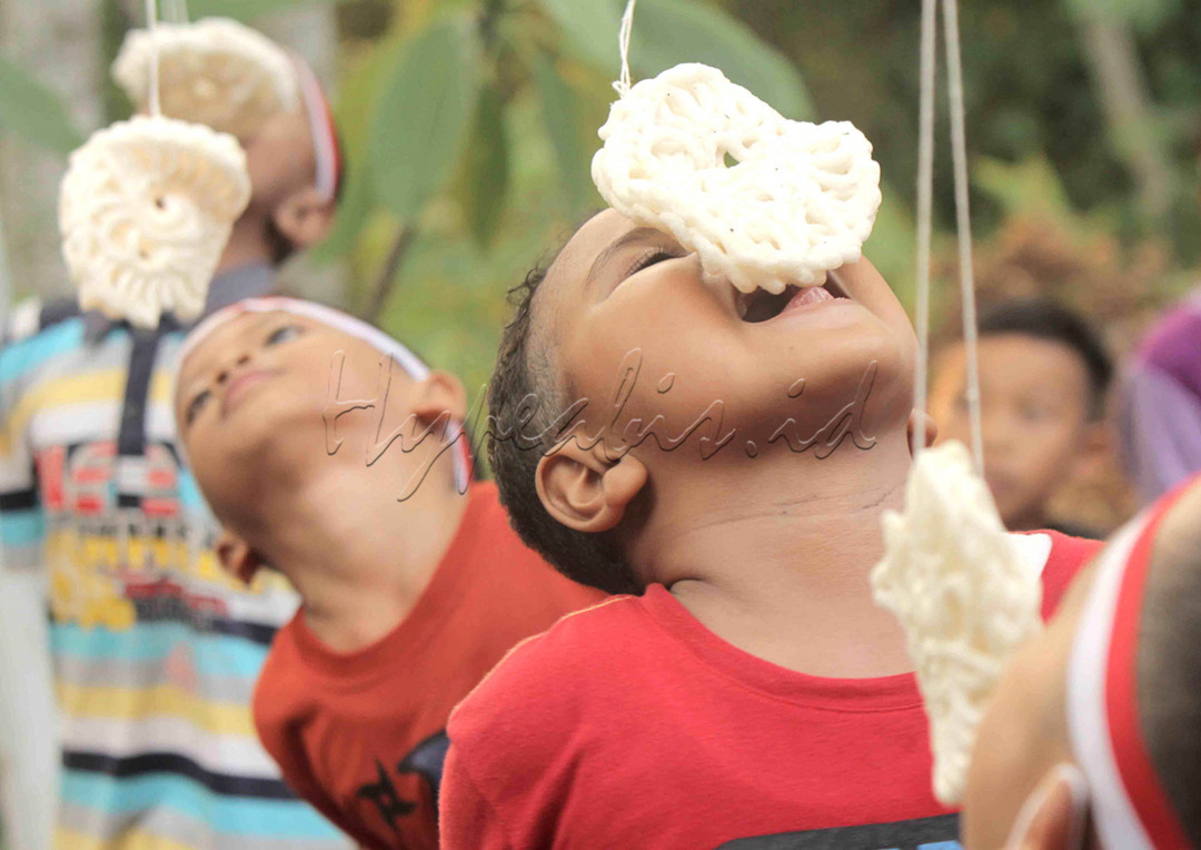 Ekspresi anak-anak saat mengikuti lomba makan krupuk dalam perayaan HUT RI ke 76 di Perum Lebo Permai Warung Asem Kab batang, 18 Agustus 2021