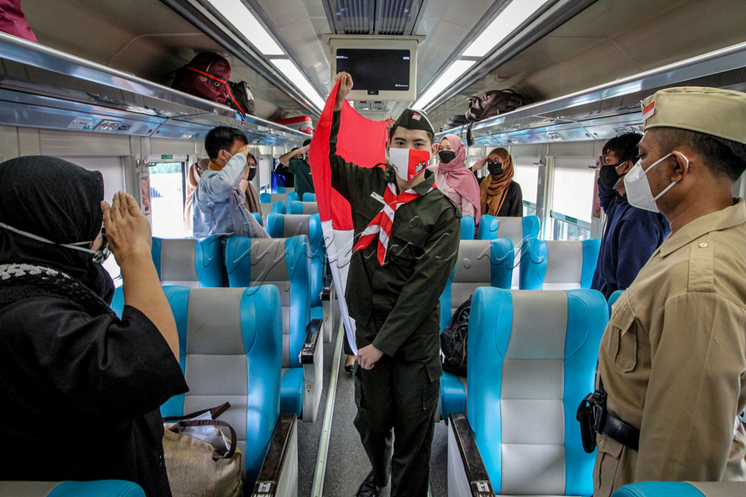 Penumpang mengikuti upacara bendera Merah Putih di dalam gerbong Kereta Api Taksaka di Stasiun Gambir, Jakarta, Selasa, (17/8/21). Dengan protokol kesehatan, penumpang memperingati hari Kemerdekaan Republik Indonesia ke-76.