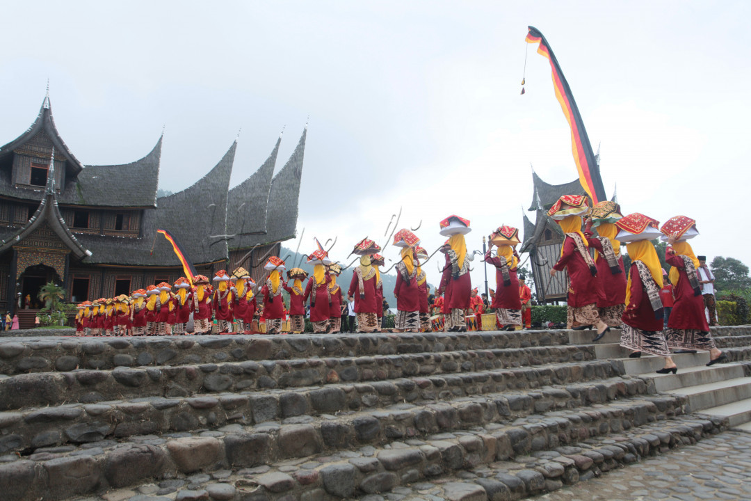 Perempuan Minangkabau atau bundo kanduang mengarak jamba 'Arak Jamba' yang berisi makanan di kawasan Istano Basa Pagaruyuang, Batusangkar, Sumbar, Minggu (19/01/2020). Tradisi Arak Jamba digelar ketika menyambut tamu yang datang atau pada pesta pernikahan.&nbsp;