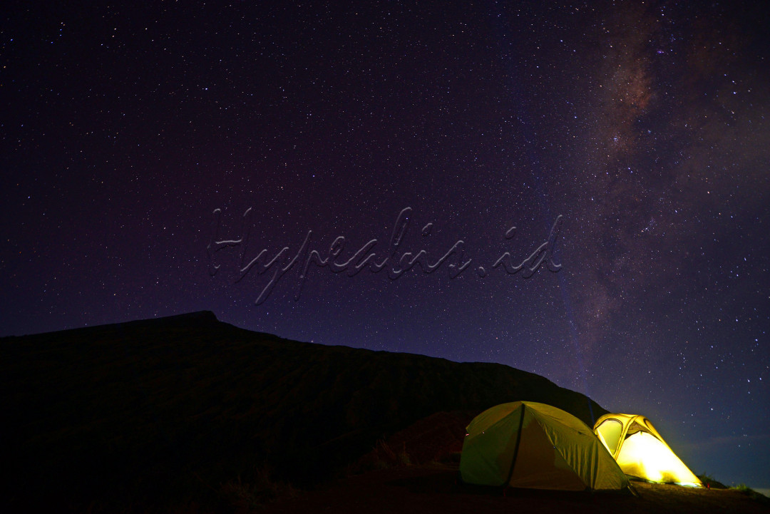 Suasana malam yang indah bertabur bintang bintang galaxy milky way di camp area pelawangan sembalun taman nasional gunung rinjani. Para wisatawan pendakian gunung rinjani mendirikan tenda dan bermalam di pos pelawangan sembalun sebelum melakukan pendakian menuju puncak (summit attack) gunung rinjani.