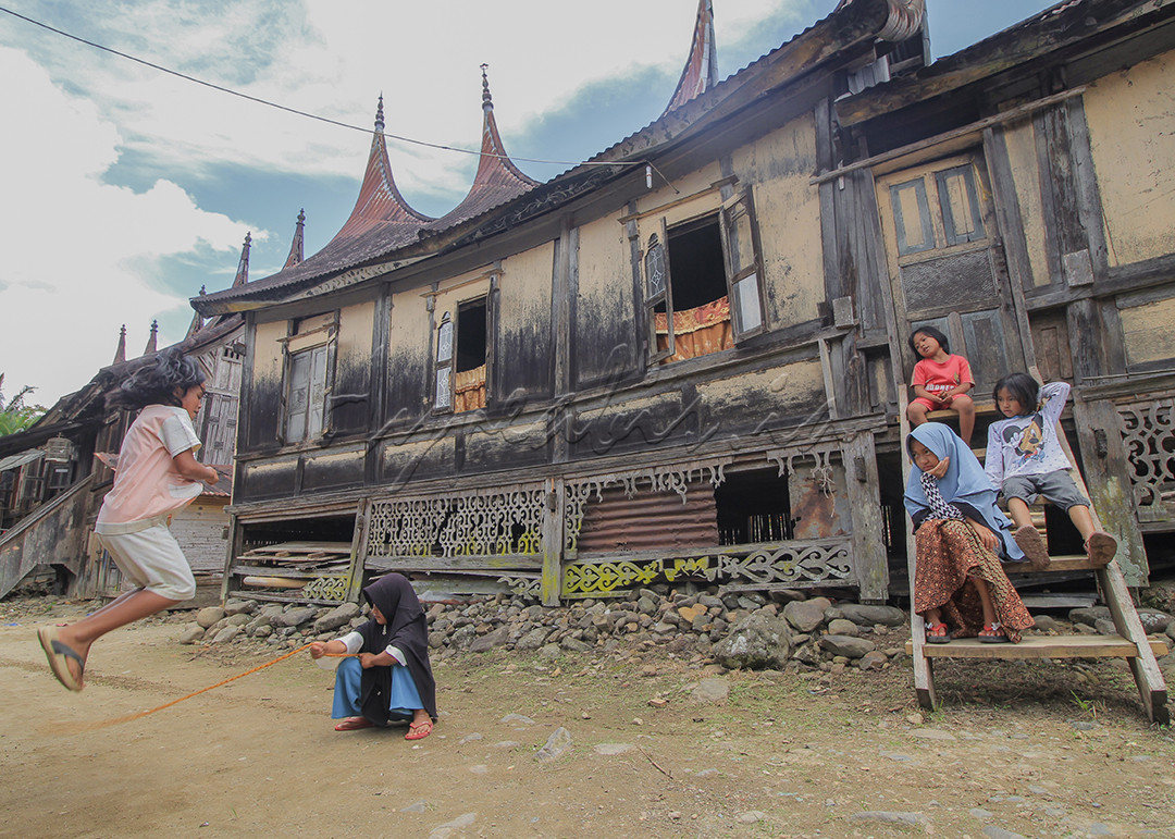 Sejumlah anak bermain tali karet di halaman rumah gadang Minangkabau di Limapuluhkota, Sumatra Barat. Permainan tradisional itu masih dimainkan anak-anak setempat &nbsp;di tengah banjirnya permainan online. Mereka tetap memainkan permainan itu sebagai upaya rasa bangga mereka terhadap permainan anak desa di Indonesia