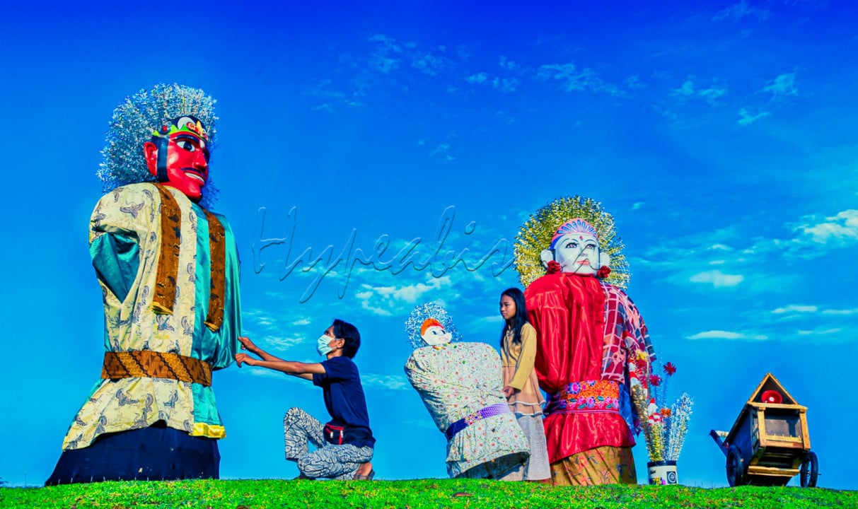 Ondel Ondel adalah warisan budaya Betawi yang patut dilestarikan. Tampak seorang ayah dan anaknya melakukan persiapan atas ondel ondel milik mereka untuk ditampilkan dalam sebuat acara di kampung