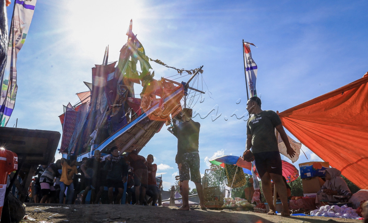 Masyarakat Cikoang bersiap untuk menggotong kapal bersama sama menuju bibir pantai