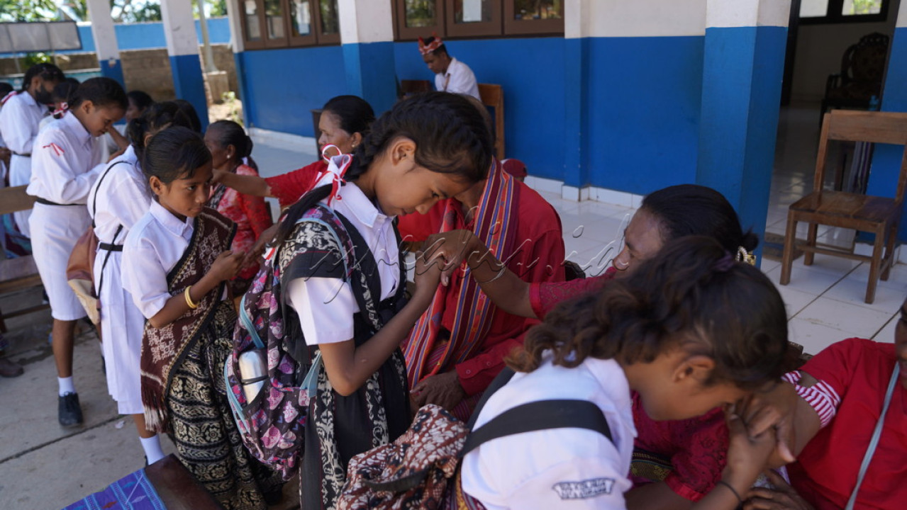 Anak-anak menyalami guru dan orang tua setelah upacara Hari Kemerdekaan ke-78 RI di SD GMIT Kolhua, Kota Kupang, Nusa Tenggara Timur, Kamis (17/8/2023). Upacara diikuti oleh semua murid dengan seragam atasan putih dan bawahan kain tenun ikhat khas Timor.