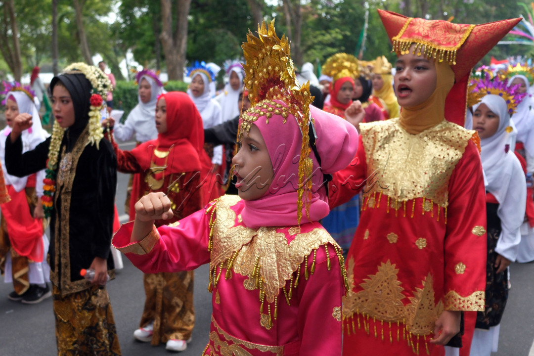Sejumlah santri mengenakan busana adat Nusantara saat Parade Budaya Nusantara di Denpasar, Bali, Minggu (22/10/2023). Kegiatan yang digelar oleh Kantor Wilayah Kementerian Agama Provinsi Bali tersebut diikuti sekitar 30 ribu santri se-Bali untuk memperingati Hari Santri Nasional.