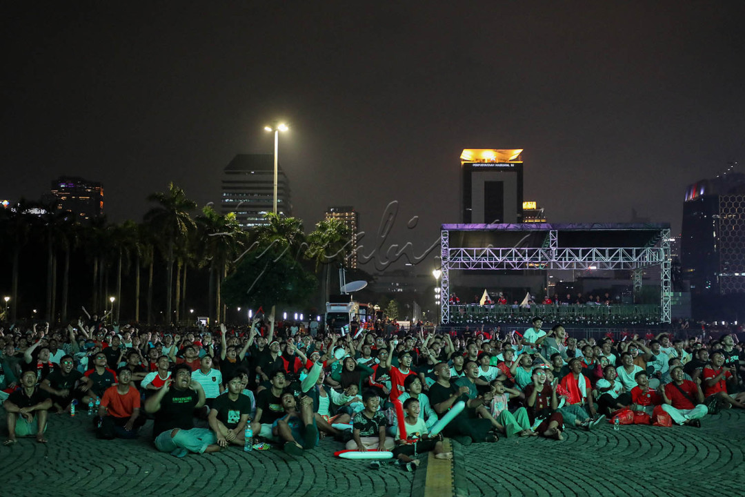 Warga menyaksikan pertandingan Timnas U-23 Indonesia melawan Timnas U-23 Irak pada perebutan Juara Ketiga AFC U-23 Piala Asia 2024 di Monas, Jakarta, Kamis (2/4/2024).&nbsp;