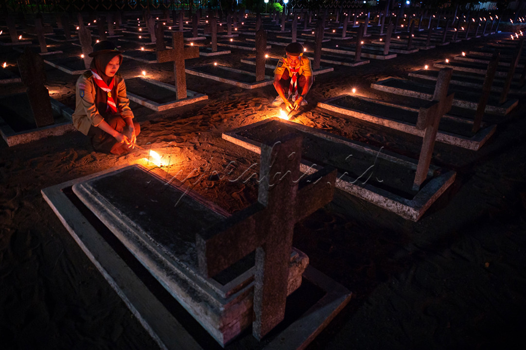 Dua anggota Pramuka menyalakan lilin saat malam Apel Kehormatan dan Renungan Suci dalam rangka memperingati Hari Kemerdekaan RI Ke-79&nbsp;di Makam Pahlawan Kusuma Negara, Semaki, Yogyakarta.