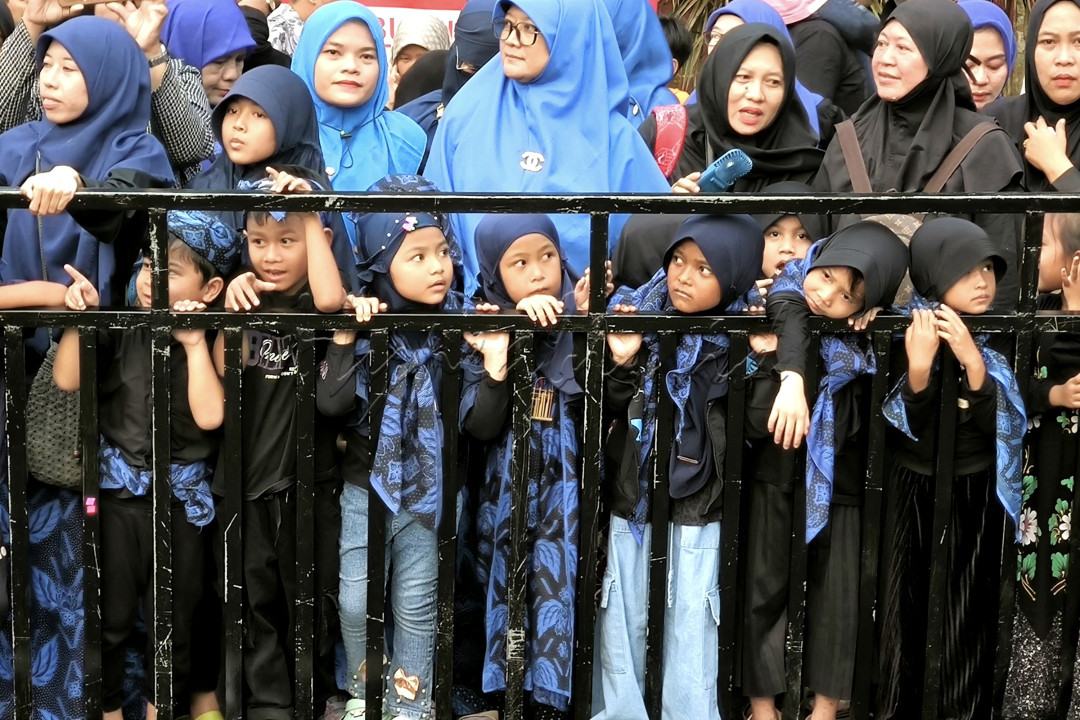 Anak anak dan orang tua sedang menunggu kedatangan parade seba baduy