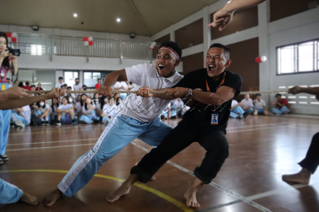 Potret keakraban dan semangat antara guru dan murid dalam lomba tarik tambang 17an. Momen ini menangkap kebersamaan yang erat dan semangat kompetisi yang sehat, memperkuat ikatan di antara mereka dalam suasana perayaan kemerdekaan.