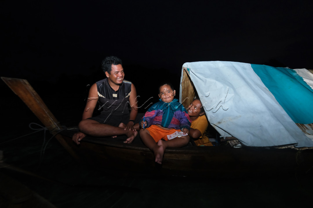 Potrait bahagia salah satu keluarga kecil suku laut yang bahagia