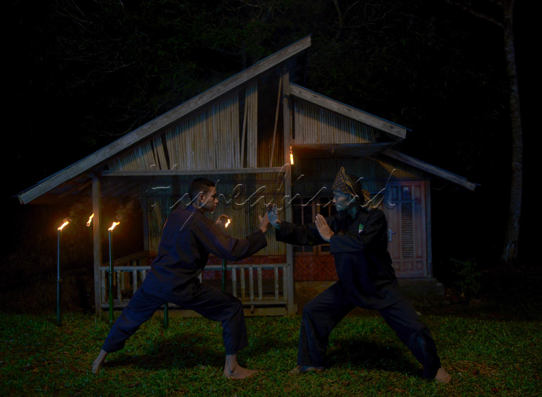 Seorang guru silat sedang melatihan anak didiknya gerakan dasar silat langkah tigo di nagari Harau Kab. Lima Puluh Kota
