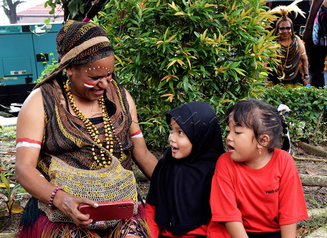 Anak anak ini begitu ngobrol hangat dengan seorang ibu dari suku Papua, saat acara carnaval budaya seluruh Provinsi Indonesia yang diadakan di kota Solo, Jawa Tengah.
