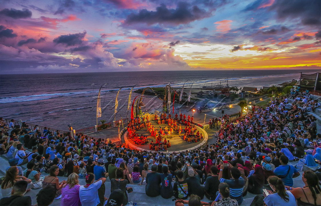SUNSET TARI KECAK &nbsp; &nbsp;Wisatawan menikmati pertunjukkan budaya tari kecak yang mendunia dan pemandangan sunset di teater di atas tebing Pantai Melasti, Bali, (16/4/24). FOTO : DWI PAMBUDO
