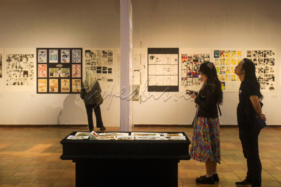 Pengunjung mengamati karya seni pada pameran komik Graphic Memoir di Bendara Budaya, Jakarta, Jumat (13/6/2025). Pameran yang berlangsung hingga 22 Juni ini diikuti 62 peserta yang terdiri dari peserta undangan, dan peserta dari <em>open call</em> atau ajakan ikut mengirim karya bagi khalayak ramai. Pameran ini menampilkan narasi visual seputar keluarga, kota asal, trauma, hingga refleksi personal.